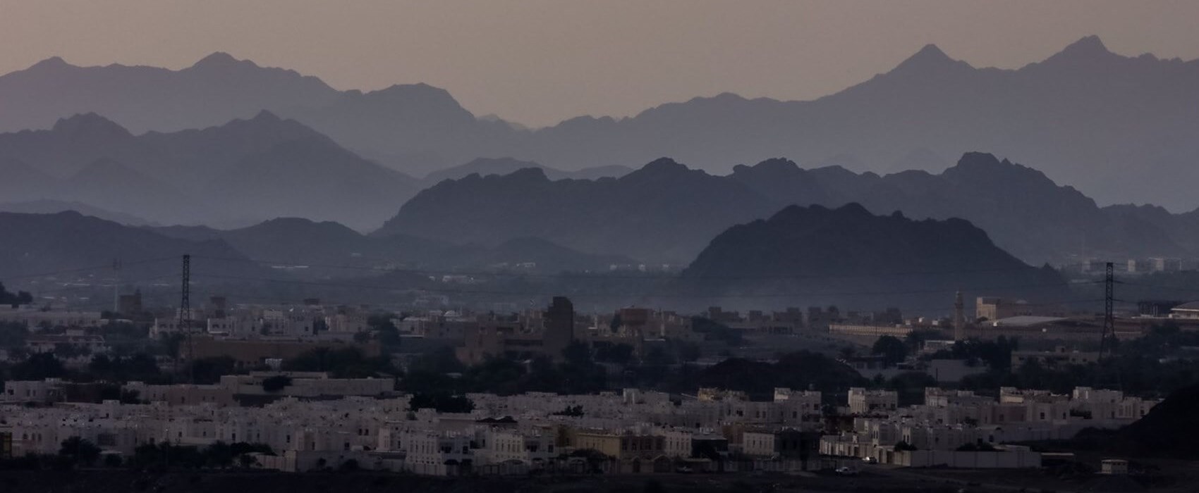 A picturesque Ajman enclave surrounded by mountains.